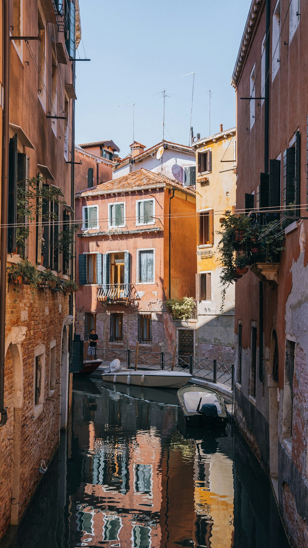 a narrow canal runs between two buildings in a city