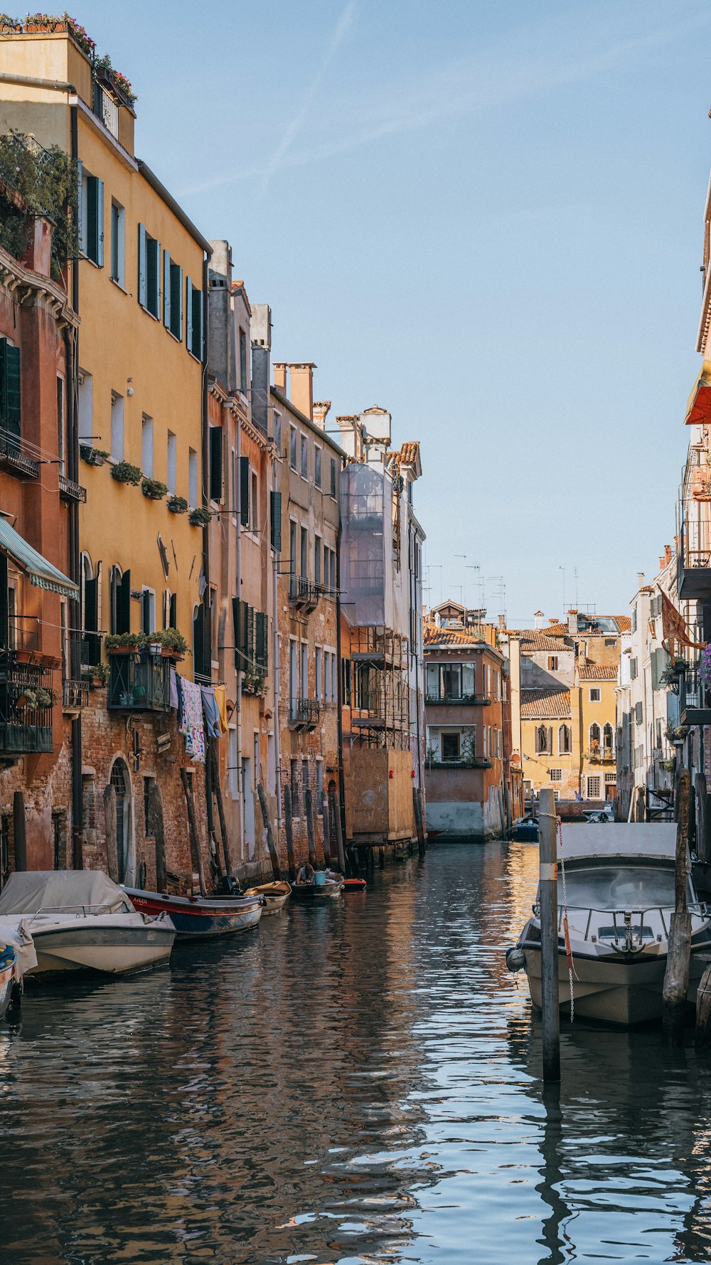 a waterway with boats and buildings on both sides