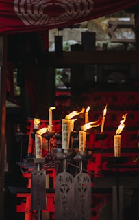 a group of lit candles sitting on top of a table