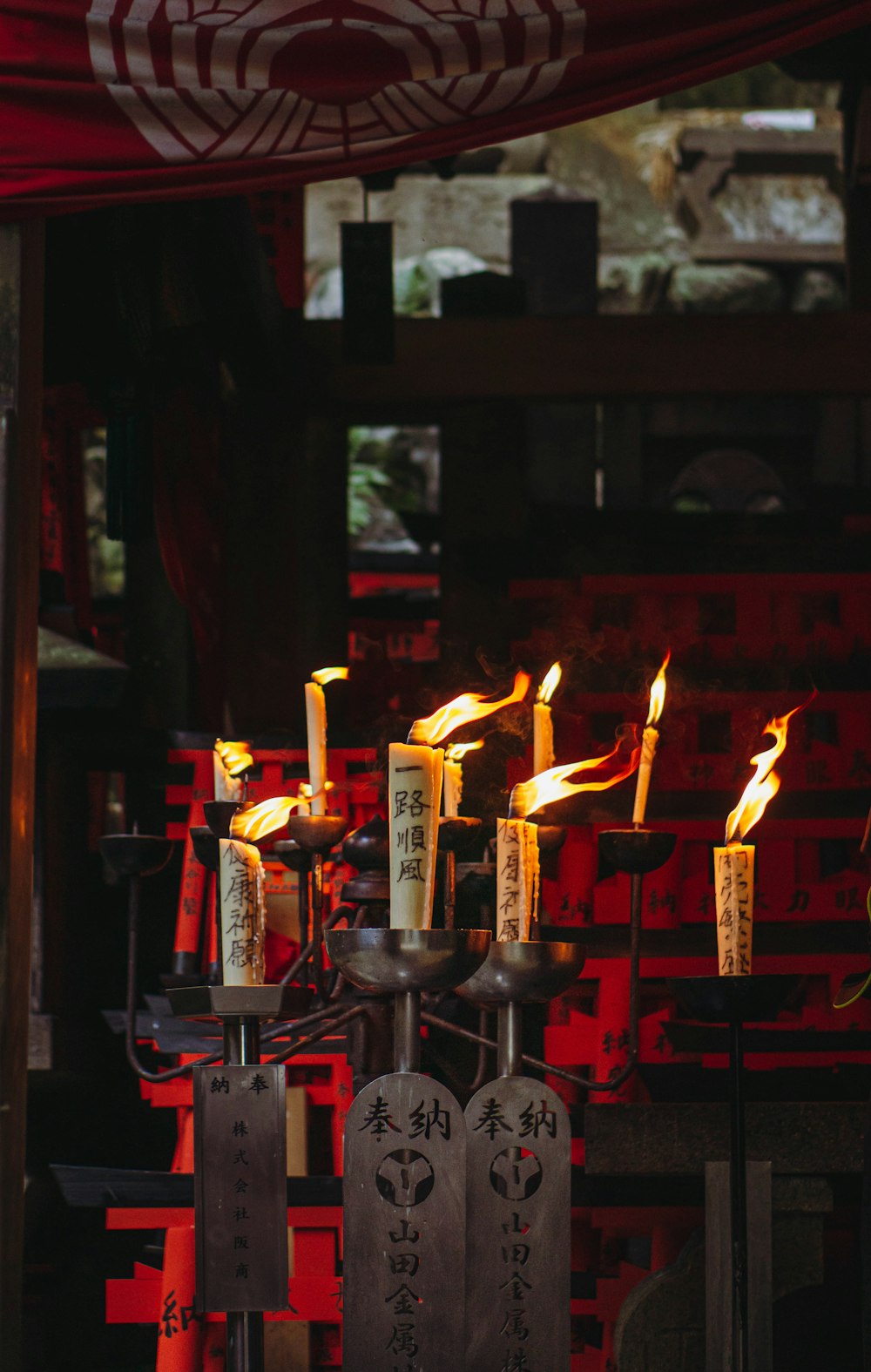 a group of lit candles sitting on top of a table