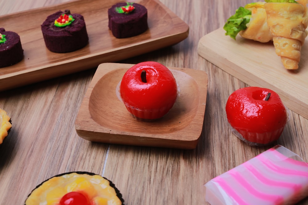 a variety of pastries on wooden trays on a table