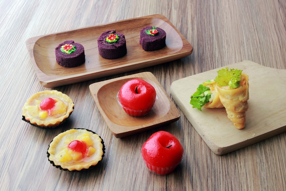 a wooden tray topped with different types of pastries