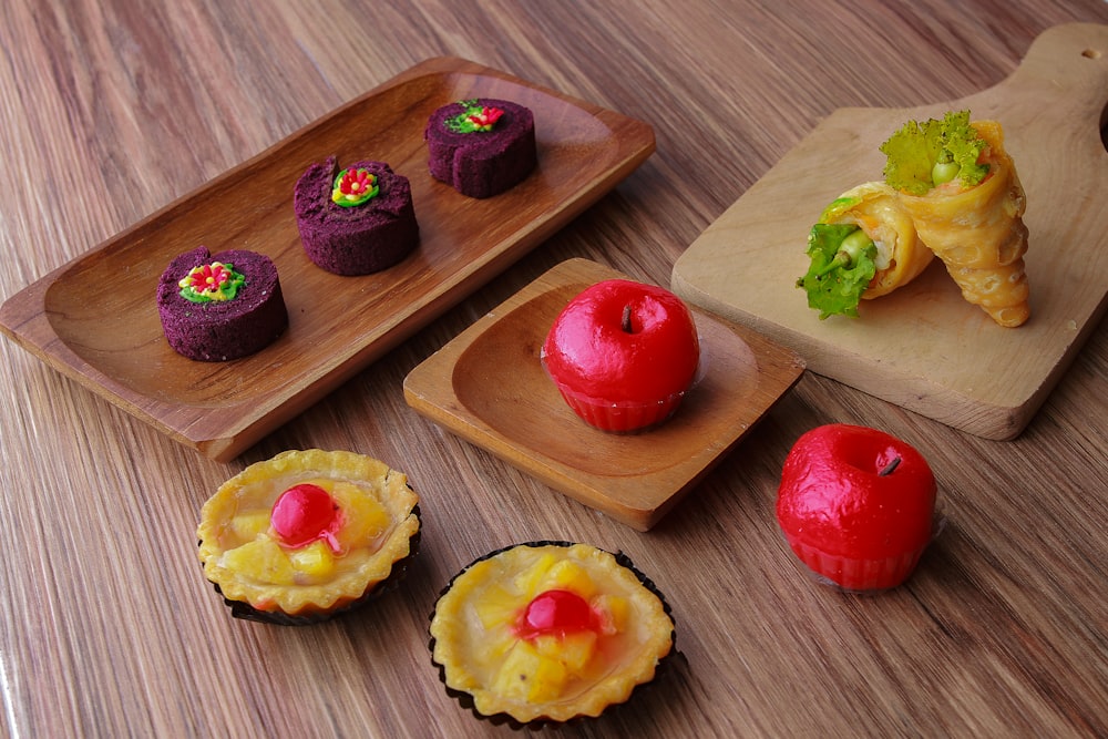 a wooden tray with pastries on it on a table