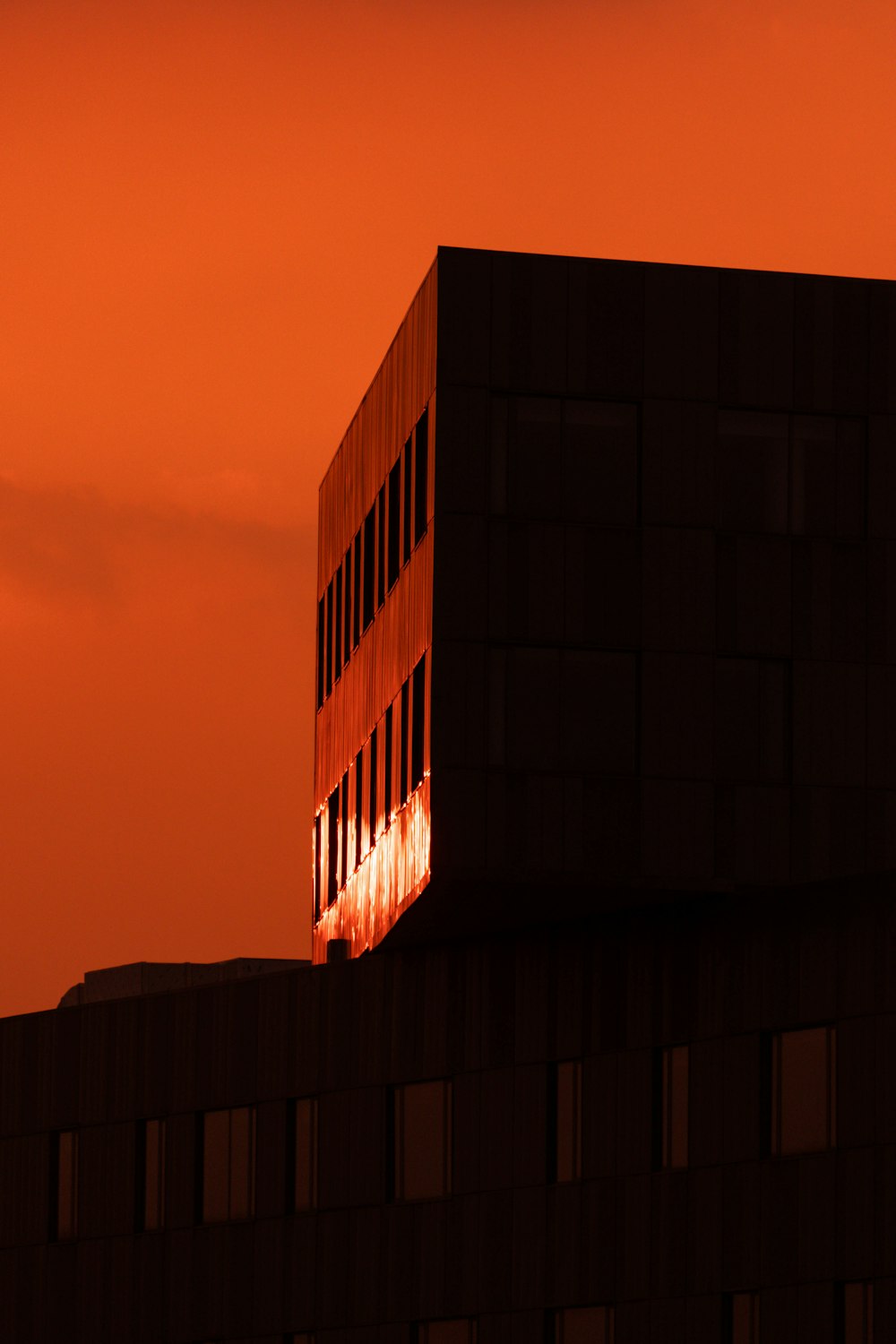 a building with a red sky in the background