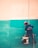 a man is painting a wall with a paint roller