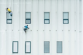 An image of professional painters at work on a building.