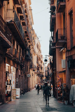 a person walking down a street next to tall buildings