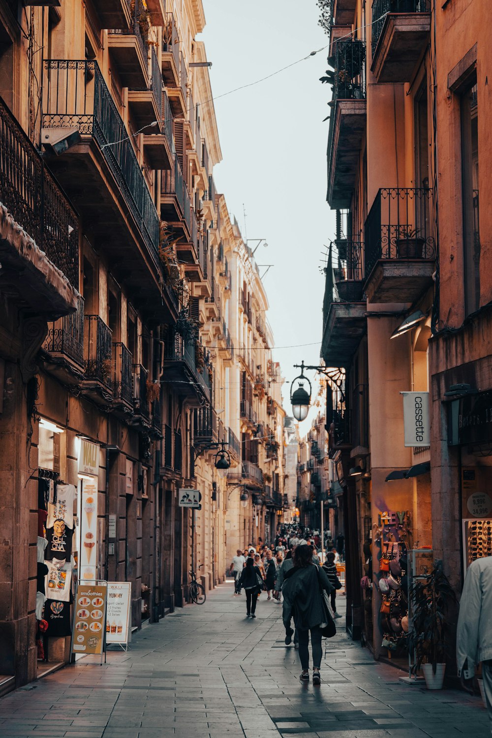 a person walking down a street next to tall buildings