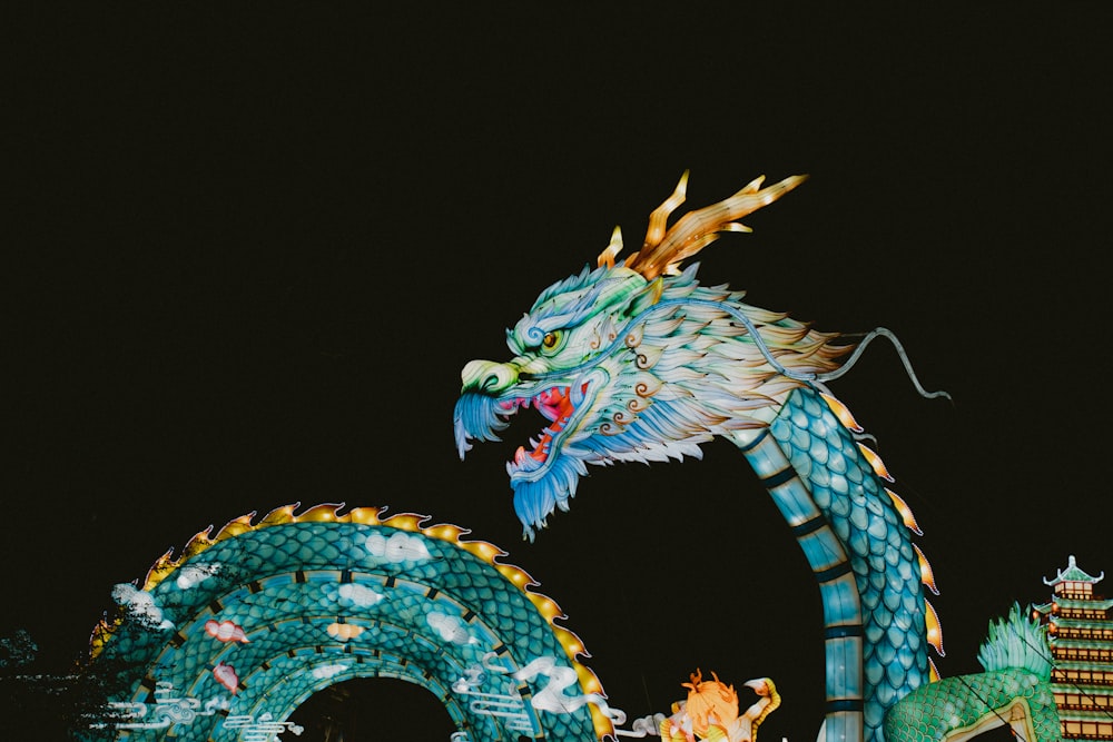 a dragon statue is lit up at night