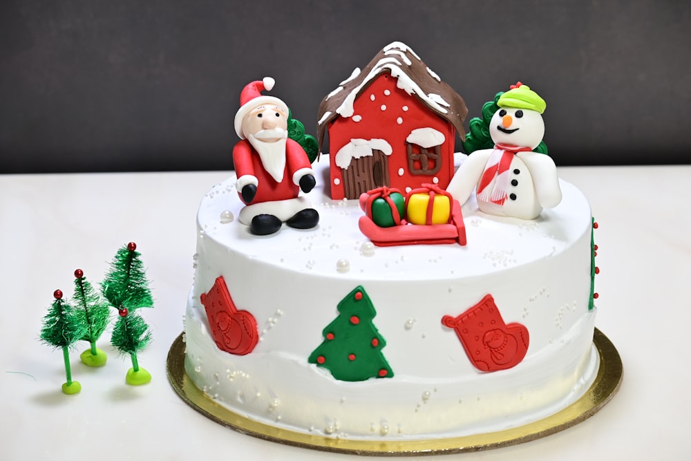a decorated christmas cake with santa and snowmen