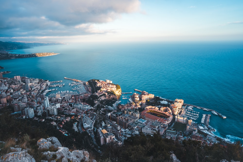 an aerial view of a city next to the ocean