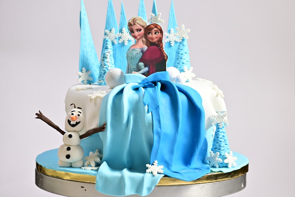 a frozen princess cake with frosting and decorations