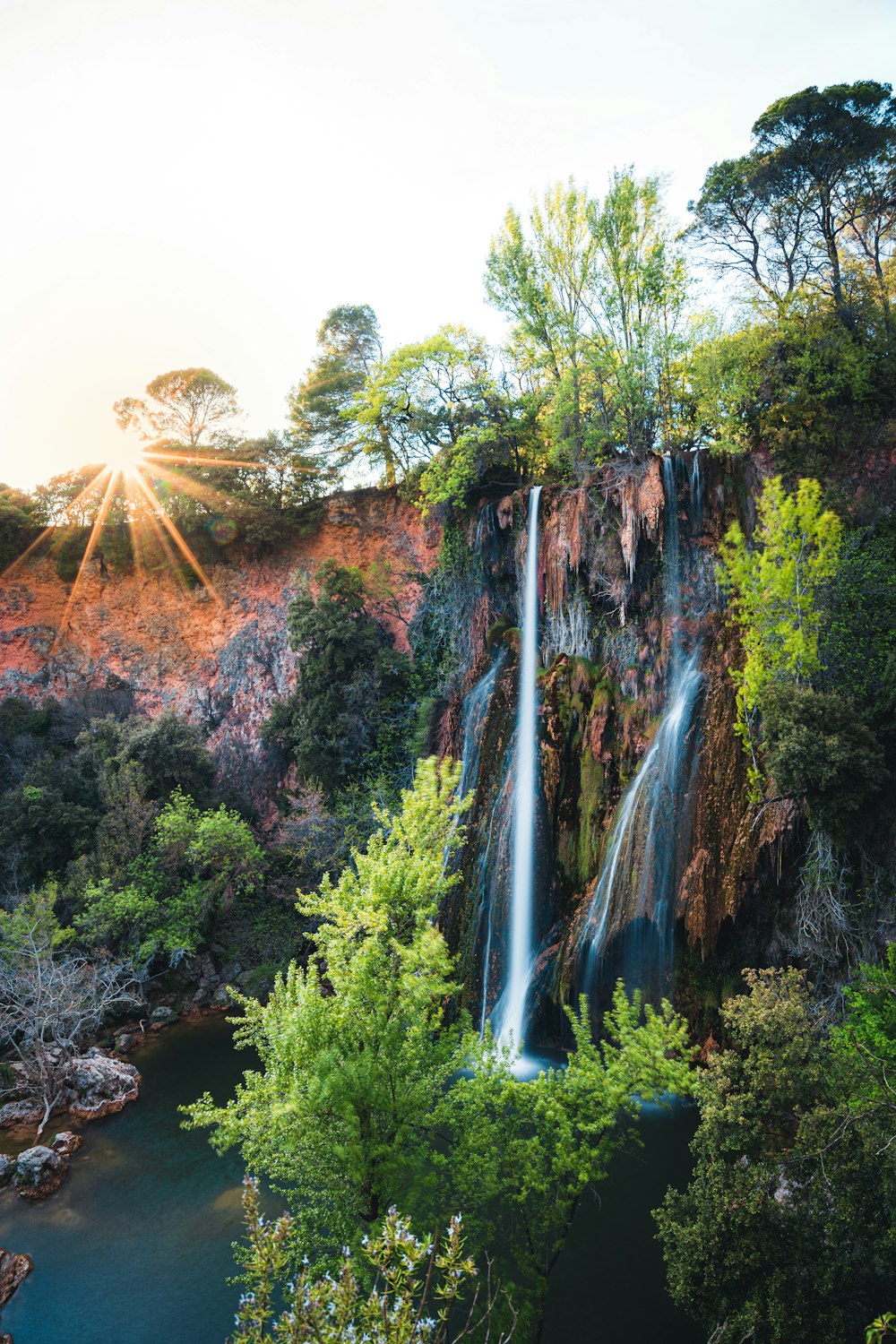 a waterfall in the middle of a forest