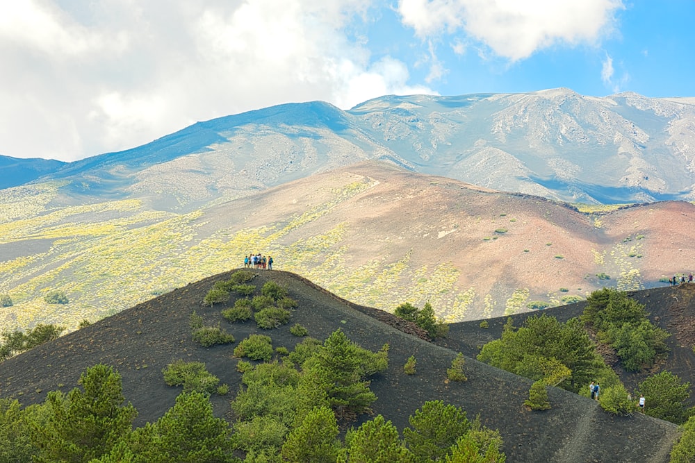 a group of people sitting on top of a mountain