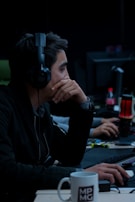 A freelancer working from a cozy home setup, headphones on, deeply focused on a project.