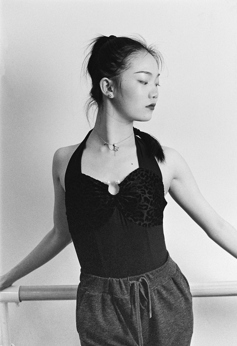 a black and white photo of a woman wearing a bra
