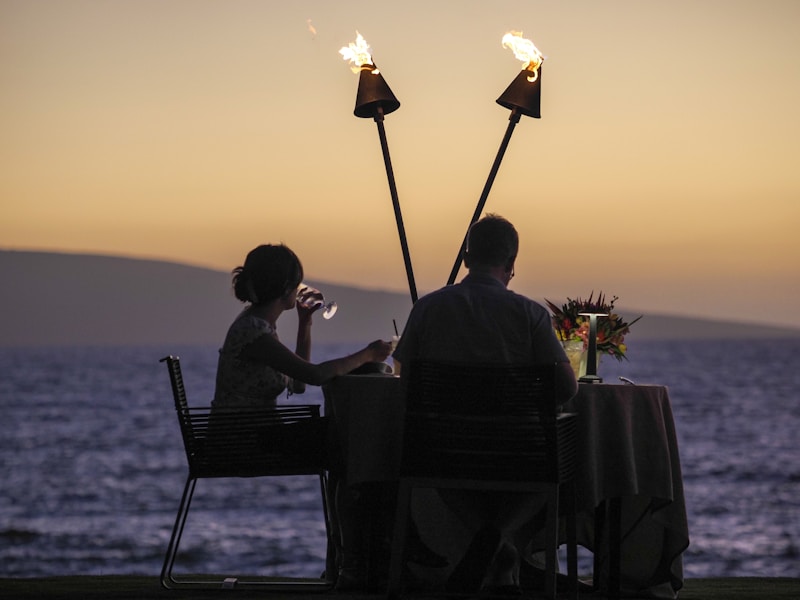 a man and a woman sitting at a table next to each other