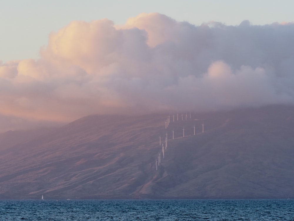 a mountain with a bunch of clouds in the sky