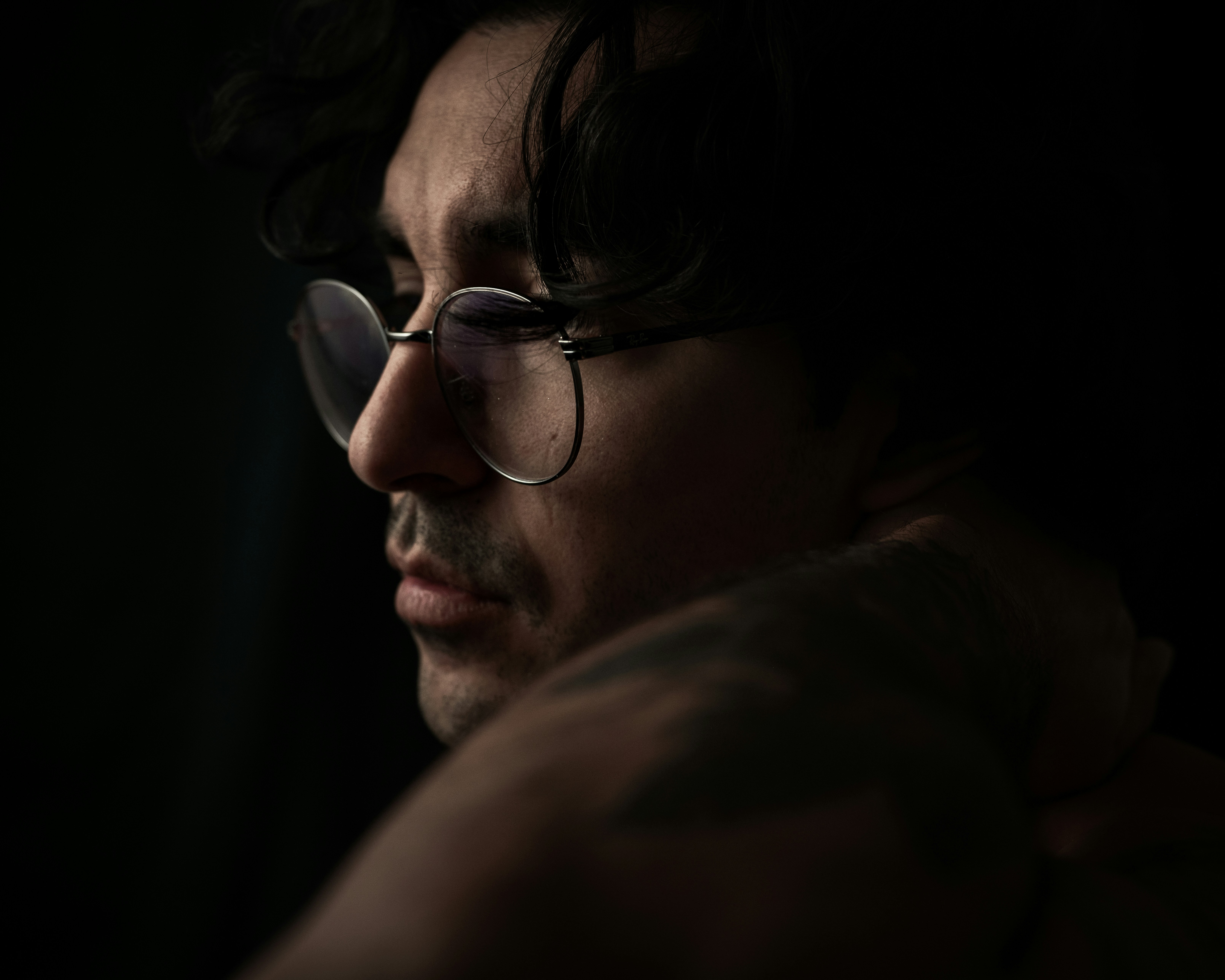 Man with glasses and no shirt on