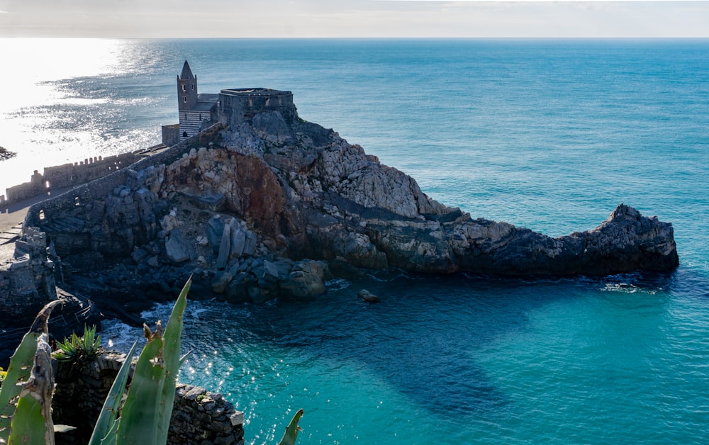 a large body of water next to a rocky cliff