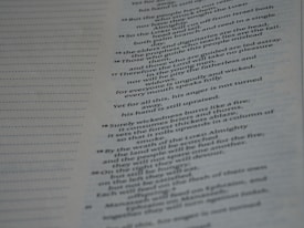 The image depicts an open book with text on one page, possibly from a religious or historical text. The page on the left has dotted lines, indicating space for notes or annotations. The text is in English and is organized in paragraphs with numbered sections.