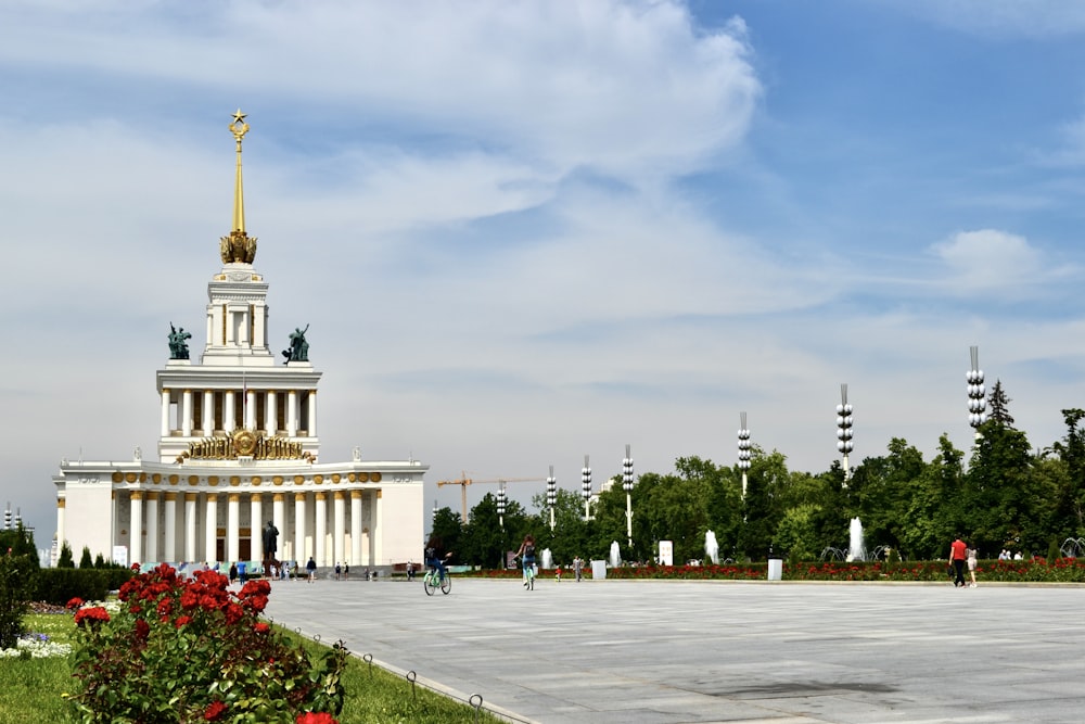 a white building with a golden statue on top of it