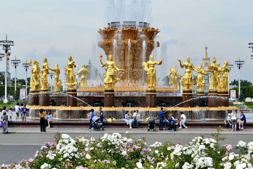 a group of people standing around a fountain