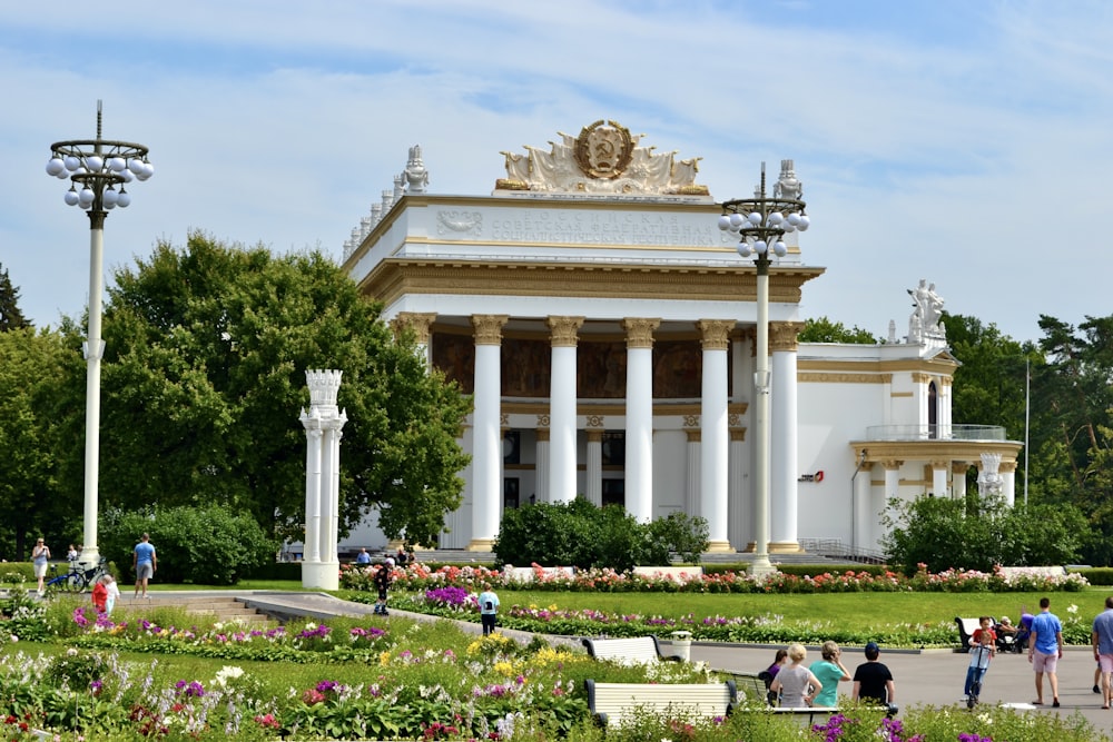 a group of people walking in front of a building