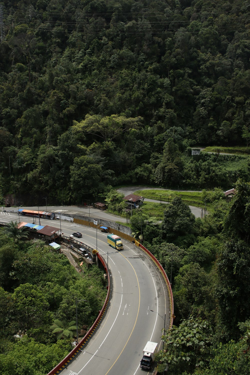 a long curved road with a bus on it