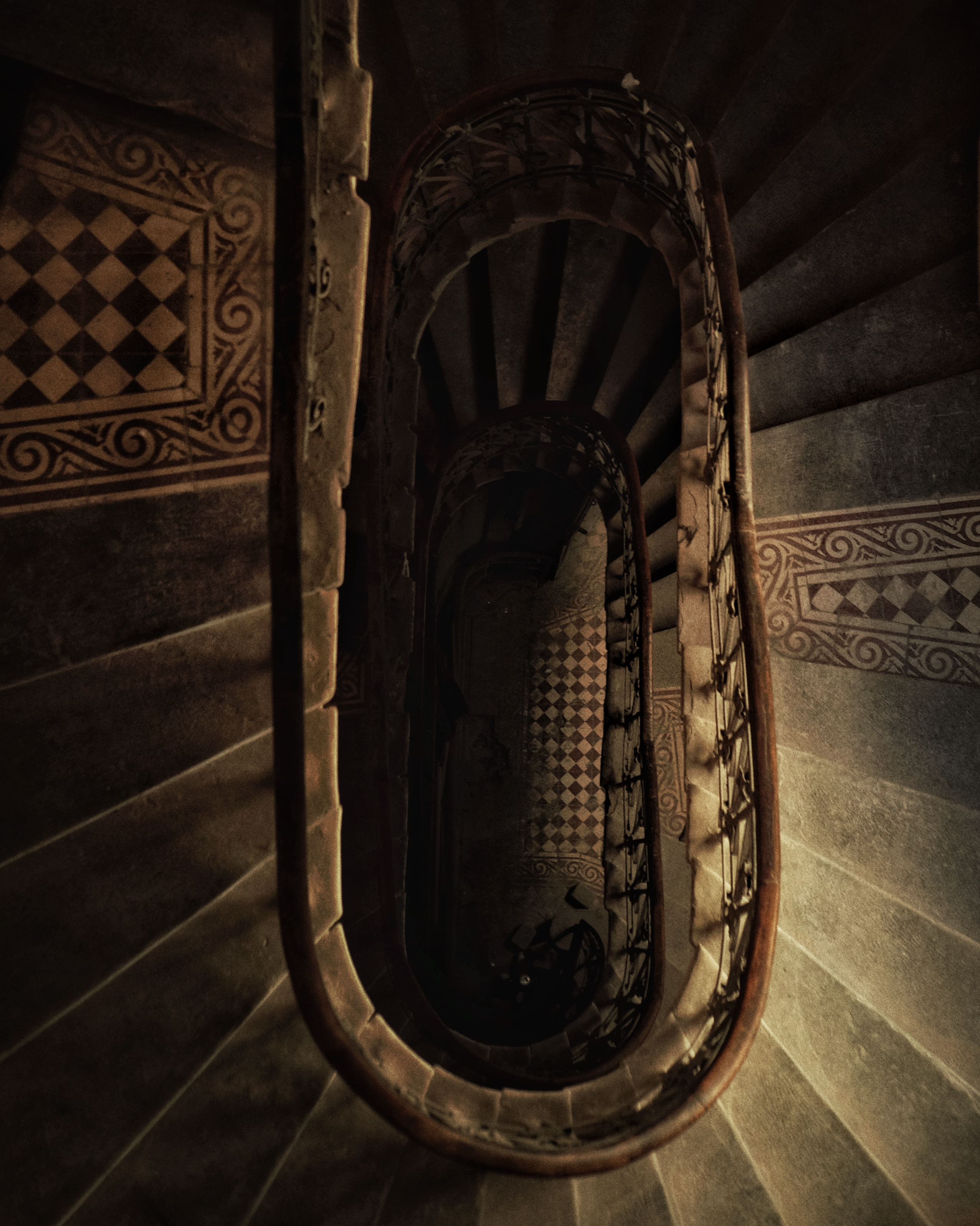 a spiral staircase in a building with a checkered floor