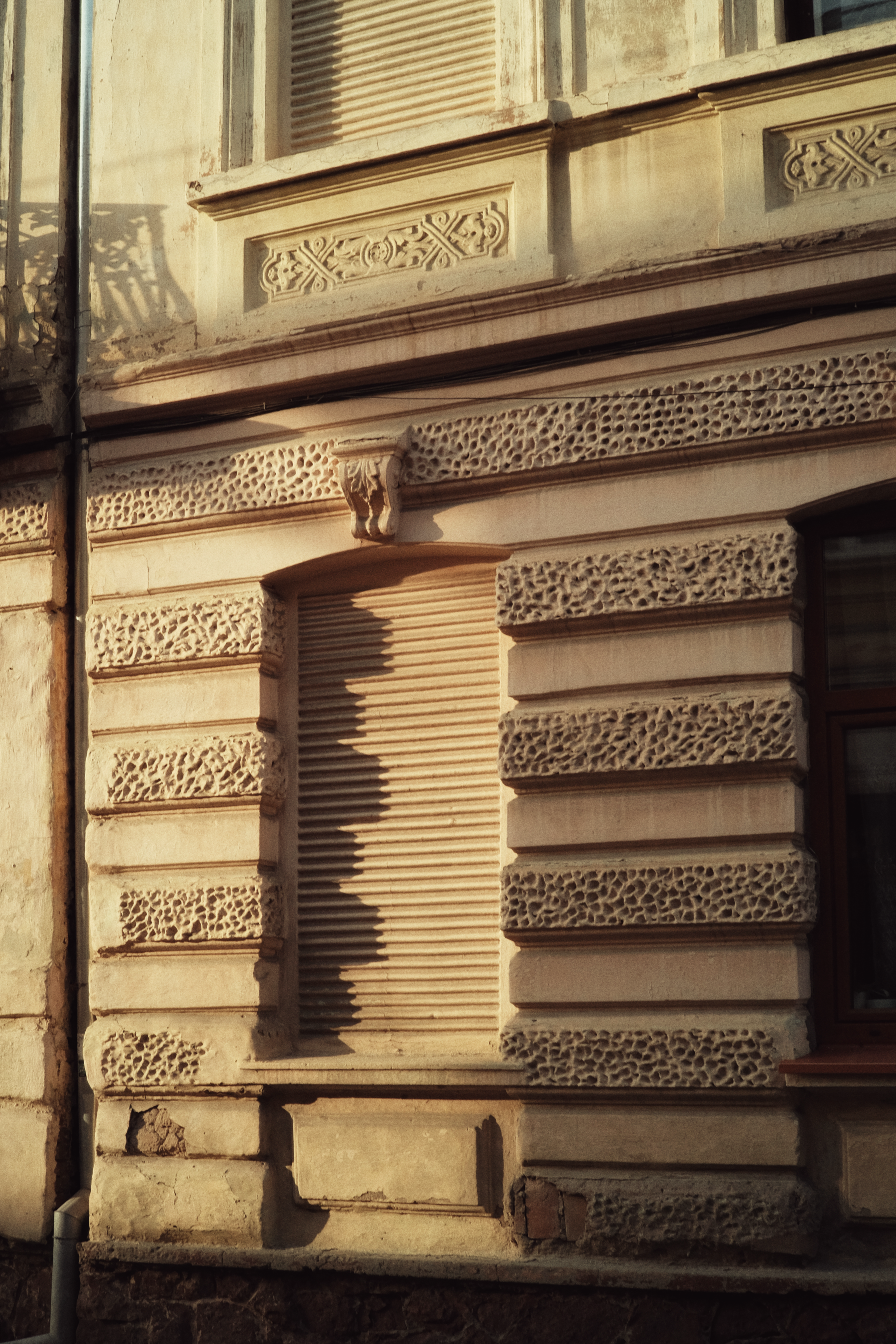 a building with a window and a clock on the side of it