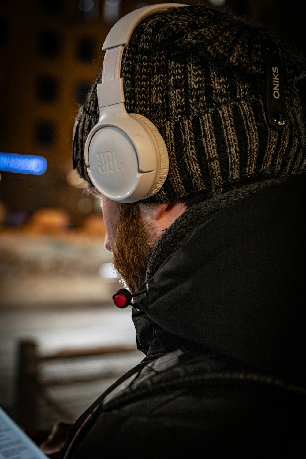 a man wearing headphones while looking at a computer screen