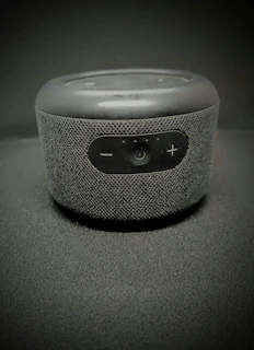 Close-up of a volume bar’s intricate speaker grille and control panel with metallic accents.