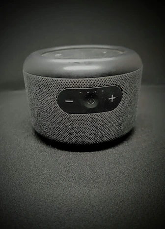 Close-up of a volume bar’s intricate speaker grille and control panel with metallic accents.