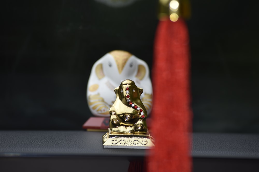 a golden statue sitting on top of a table