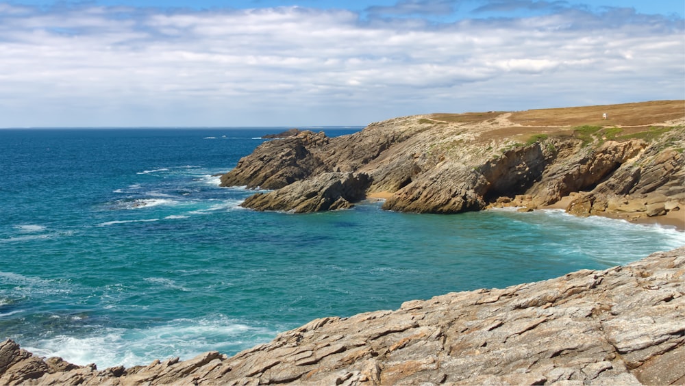 a view of the ocean from a rocky cliff