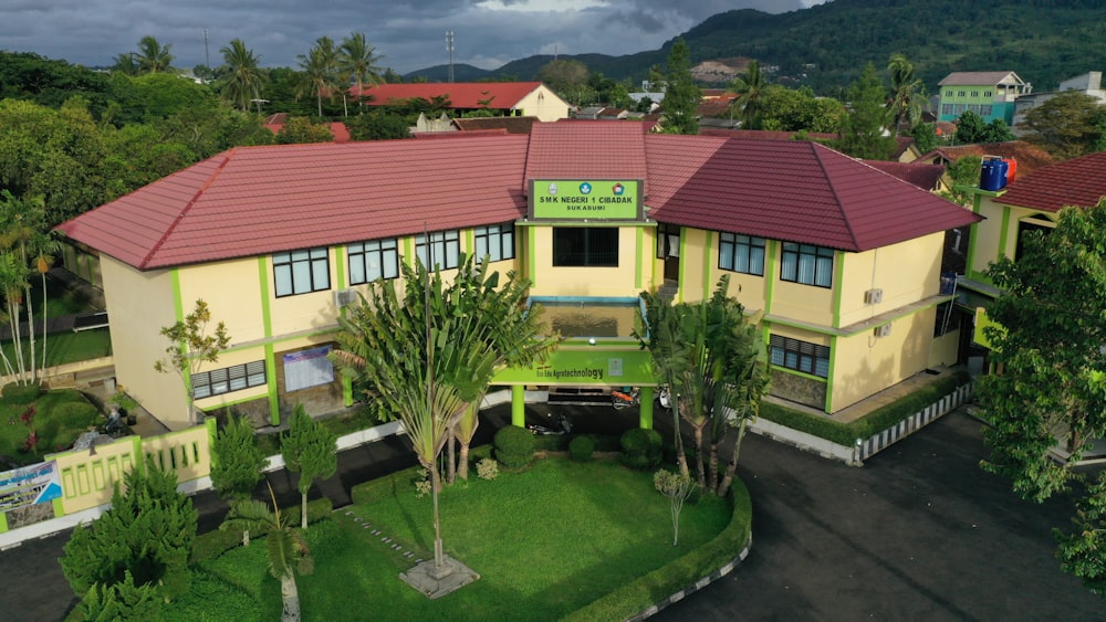 an aerial view of a building with a red roof