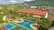 An aerial view of a vibrant school courtyard with a large sports area featuring multiple courts painted in blue, red, yellow, and green. The school building has a long, red roof and is surrounded by palm trees and greenery. In the background, a lush, mountainous landscape is visible alongside a densely packed residential area.