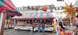 A festive market stall decorated with banners announcing special sales.
