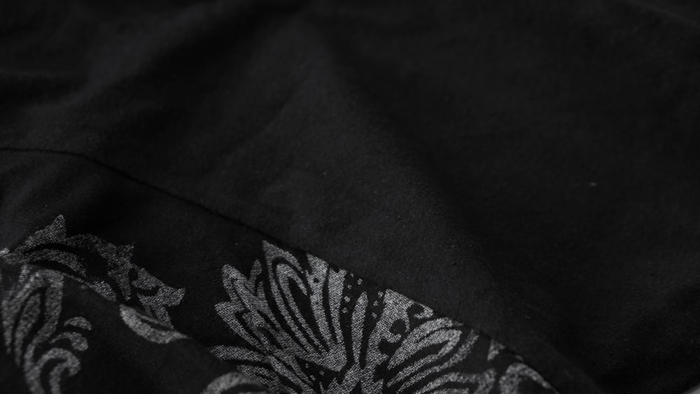 a close up of a black shirt with a pattern on it