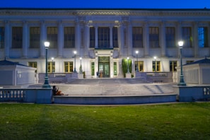 Evening shot of a public library with illuminated glass facade and inviting entrance