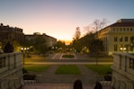 A scenic view of an international university campus with students walking between buildings.
