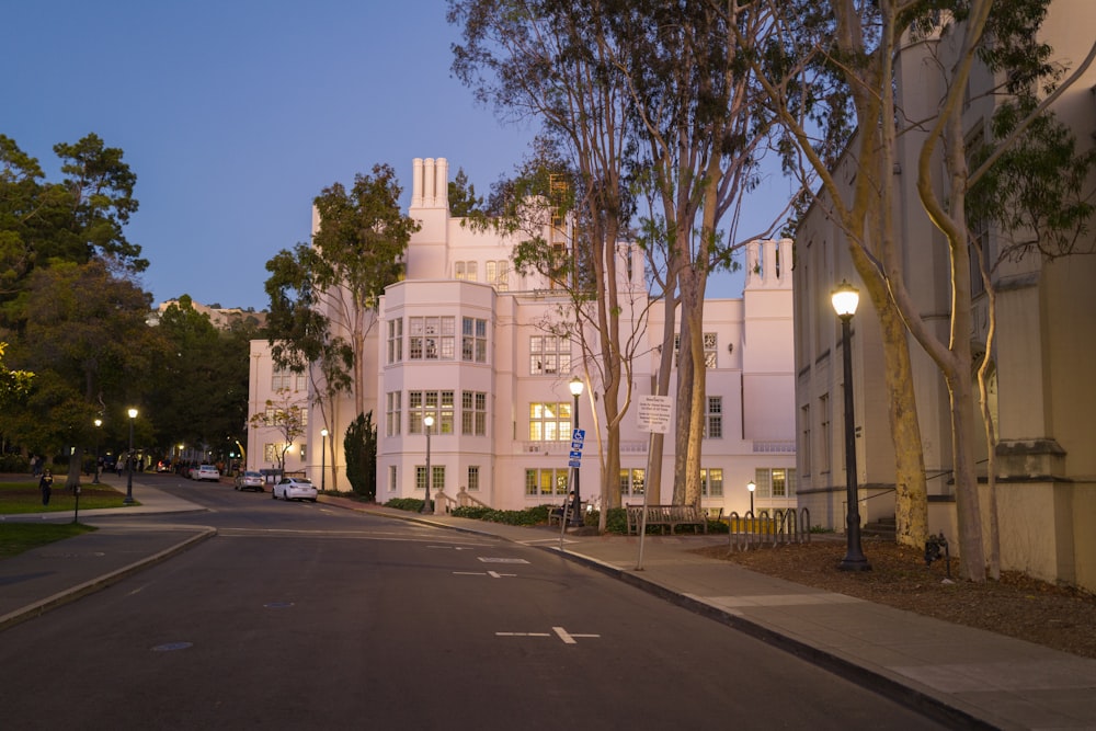 a street lined with tall white buildings and trees