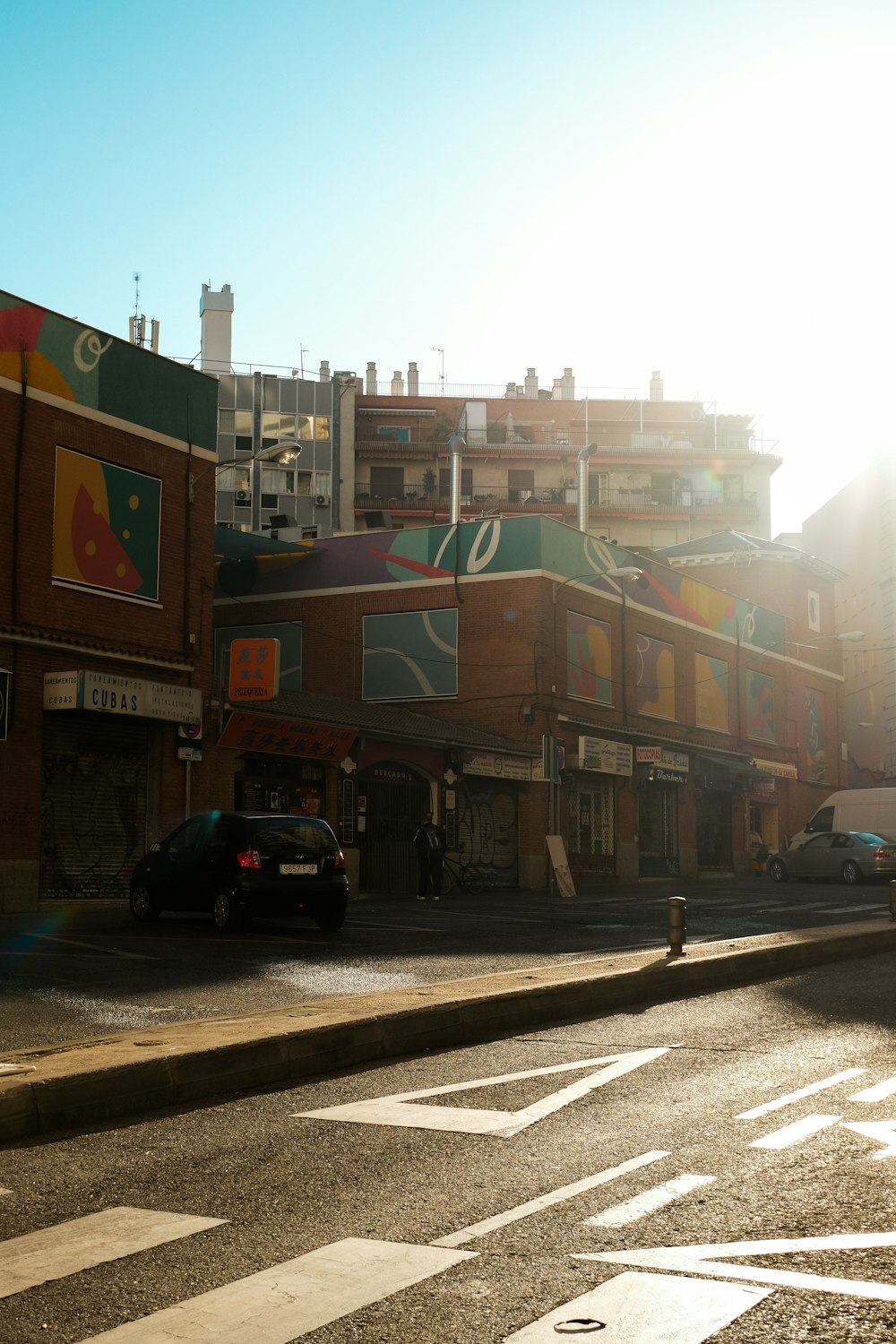 a city street with cars parked on the side of the road