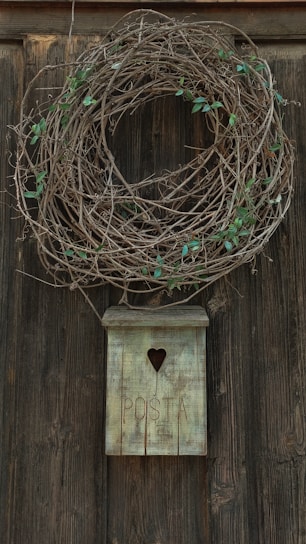 A handcrafted wooden mailbox with intricate carvings and a rich natural finish, standing beside a charming garden path.