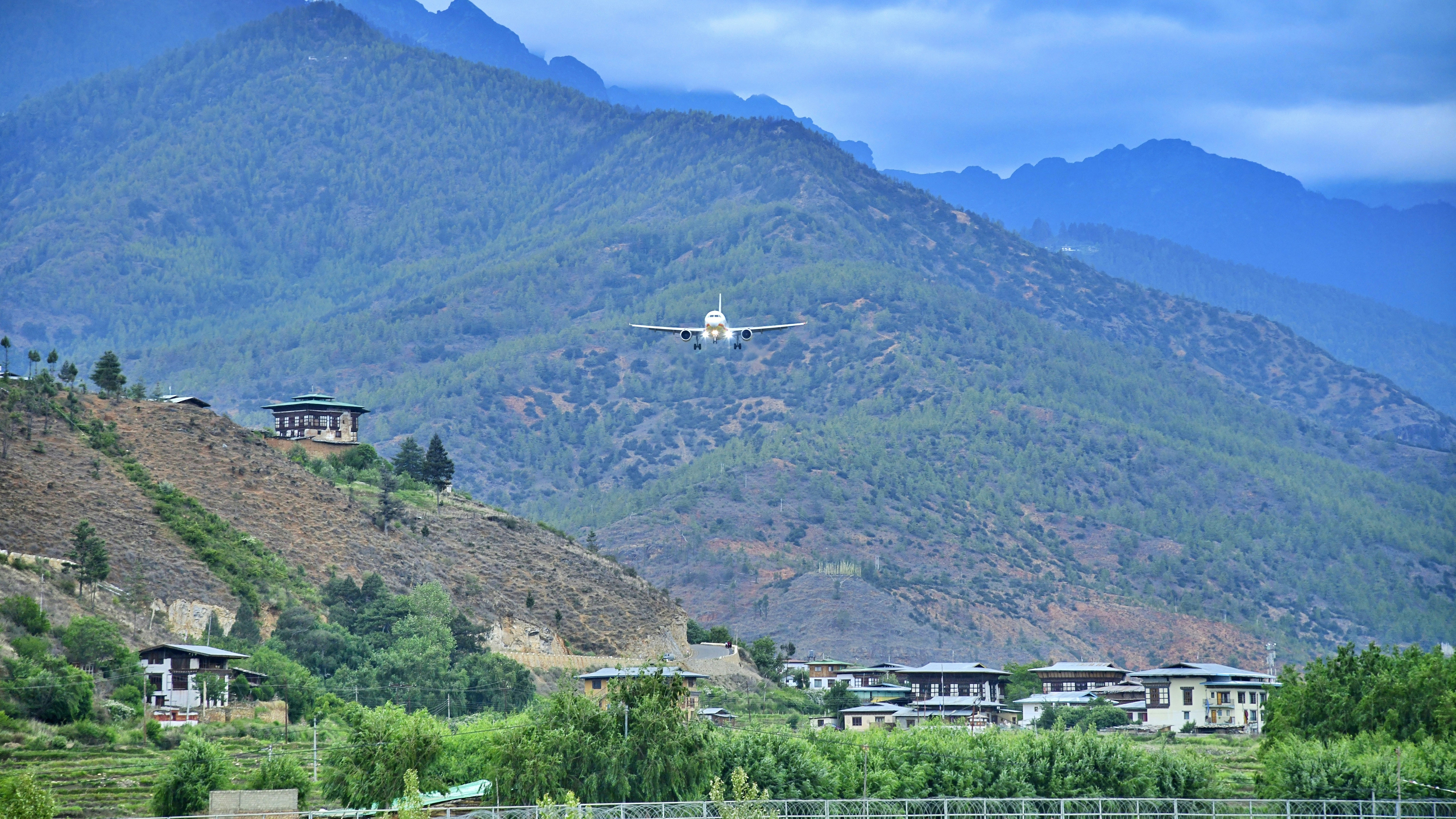 a plane is flying over a mountain town