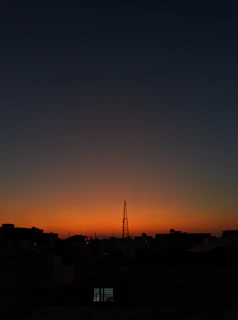 A city skyline at dusk with communication towers subtly highlighted, symbolizing Evonet’s reach.