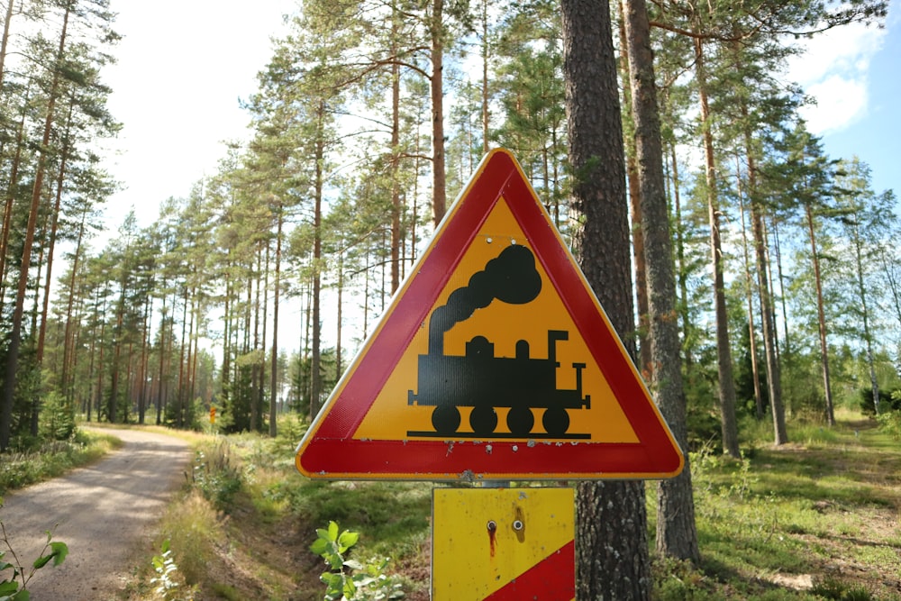 a sign warning of a train crossing in the woods