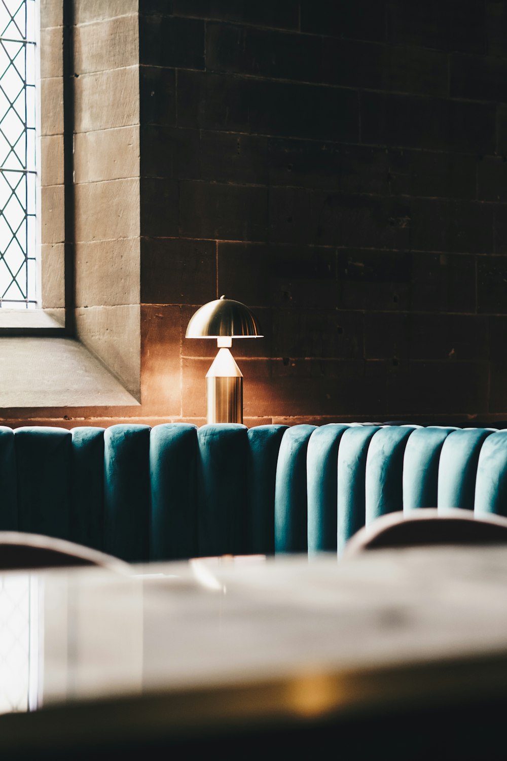 a room with a couch and a table with a lamp on it