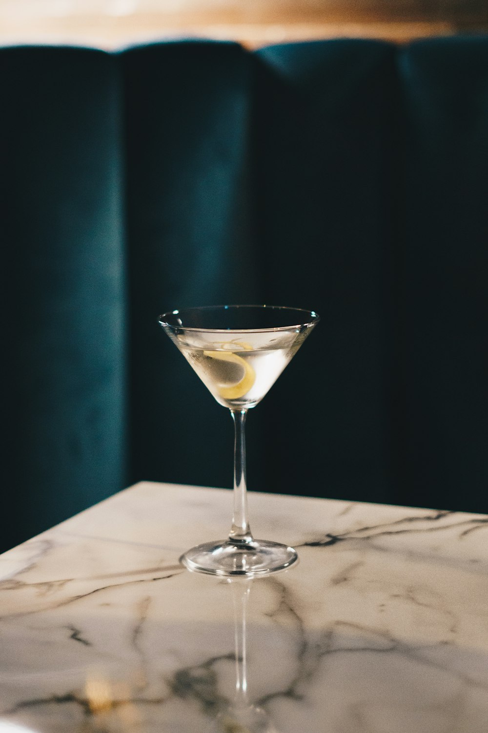 a martini sitting on top of a marble table